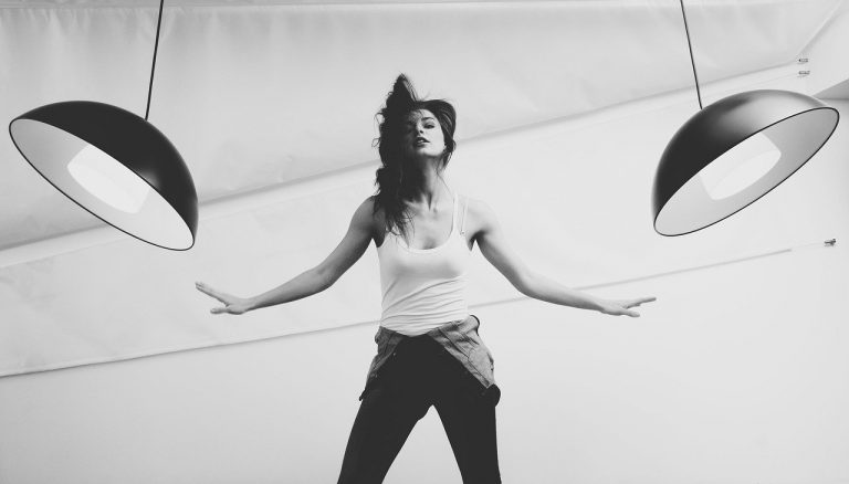 Interior of photography studio with lights and various equipment and props.