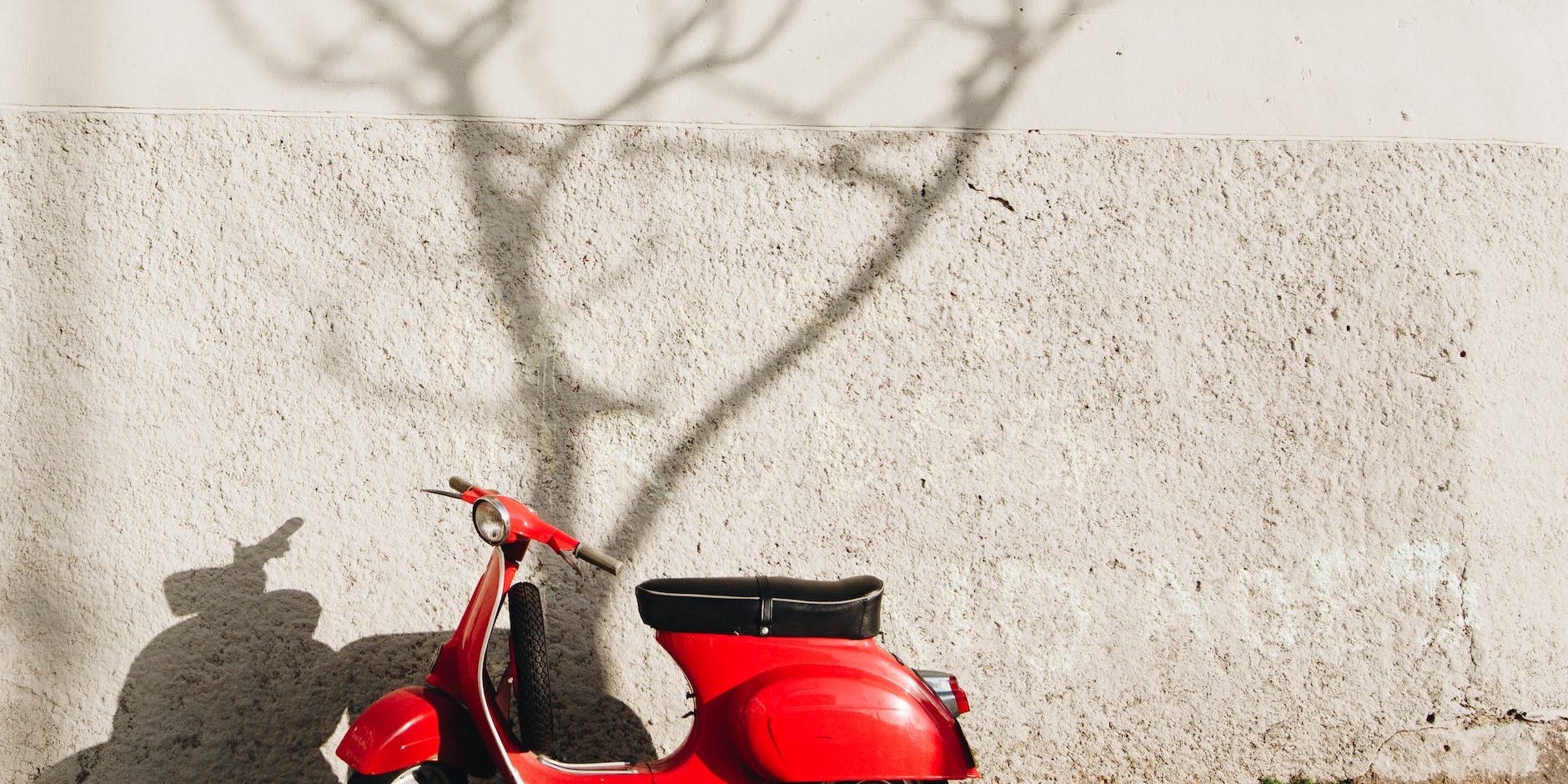 red motor scooter near wall