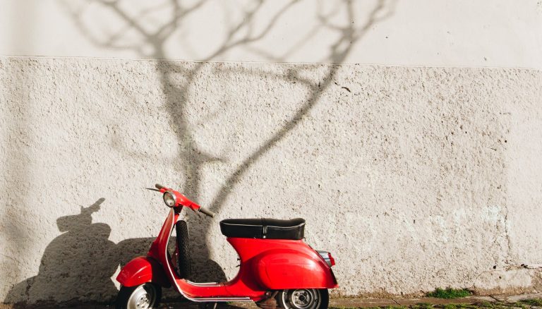 red motor scooter near wall