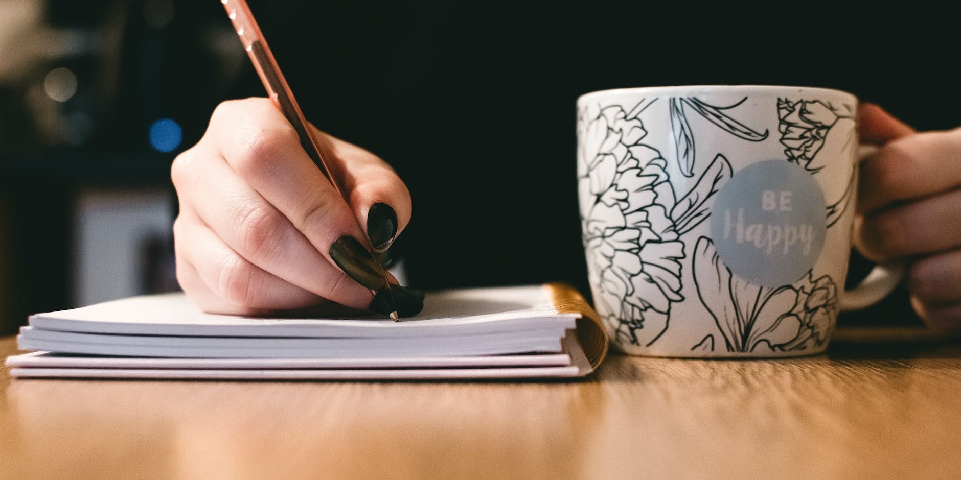 person holding white ceramci be happy painted mug