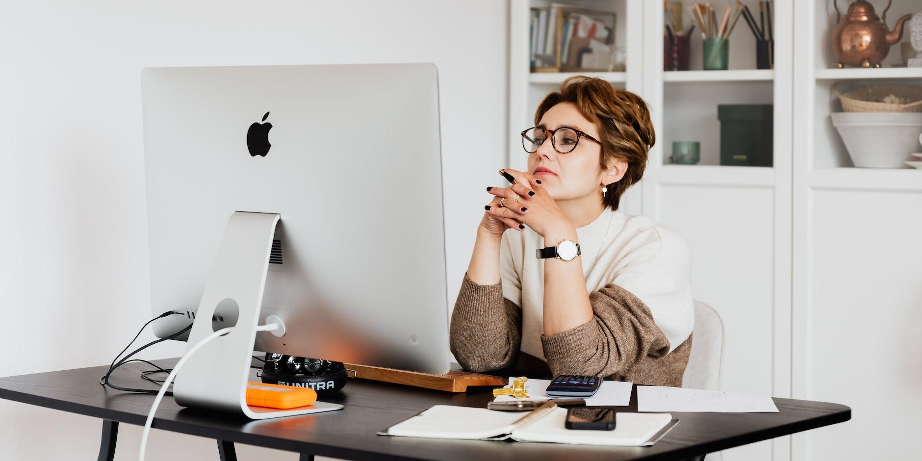 focused female employee reading information on computer in office