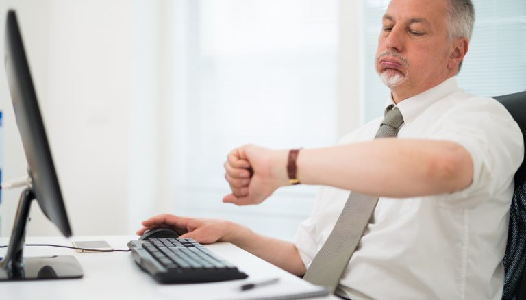 A person sitting at a desk Description automatically generated