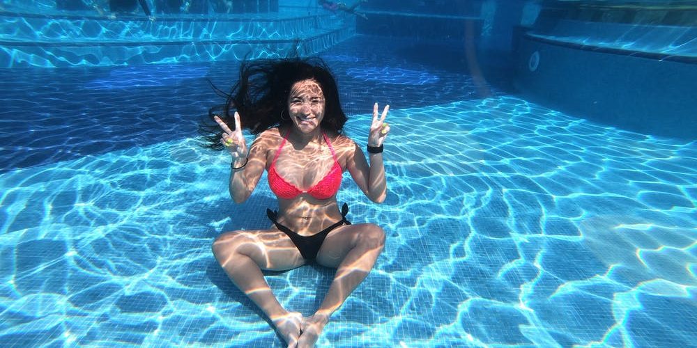 Woman Wearing Red and Black Bikini Under Pool