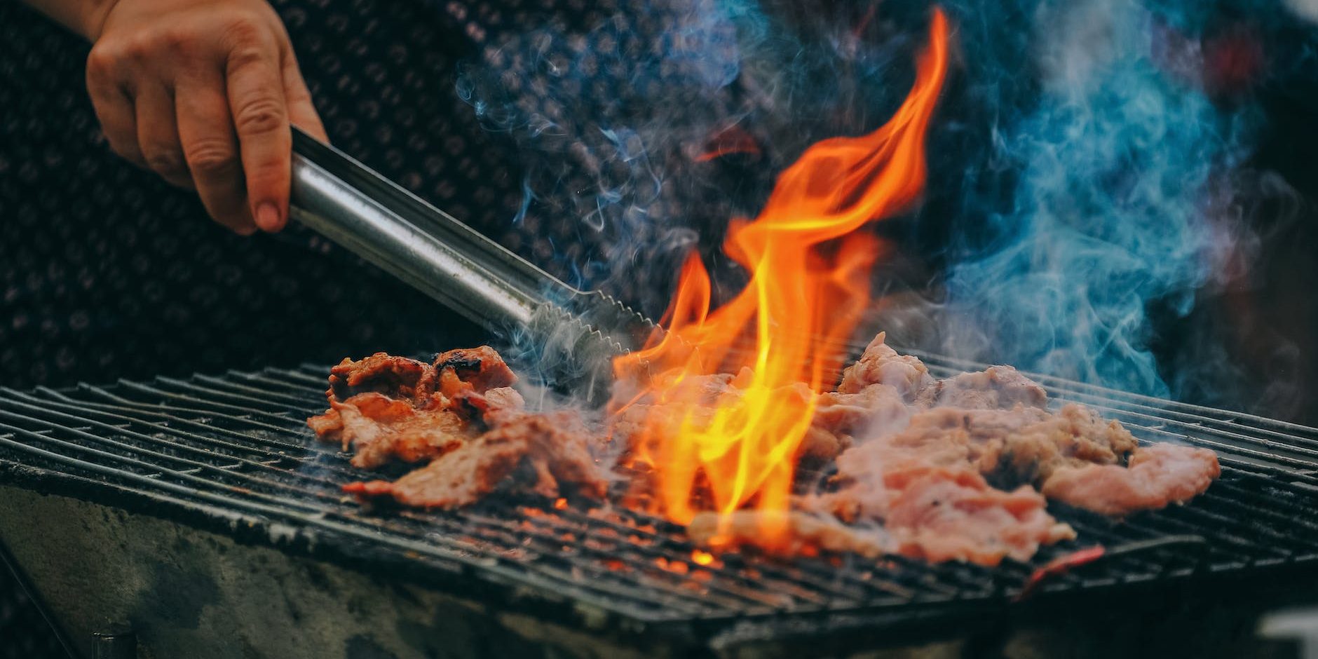 close up photo of man cooking meat