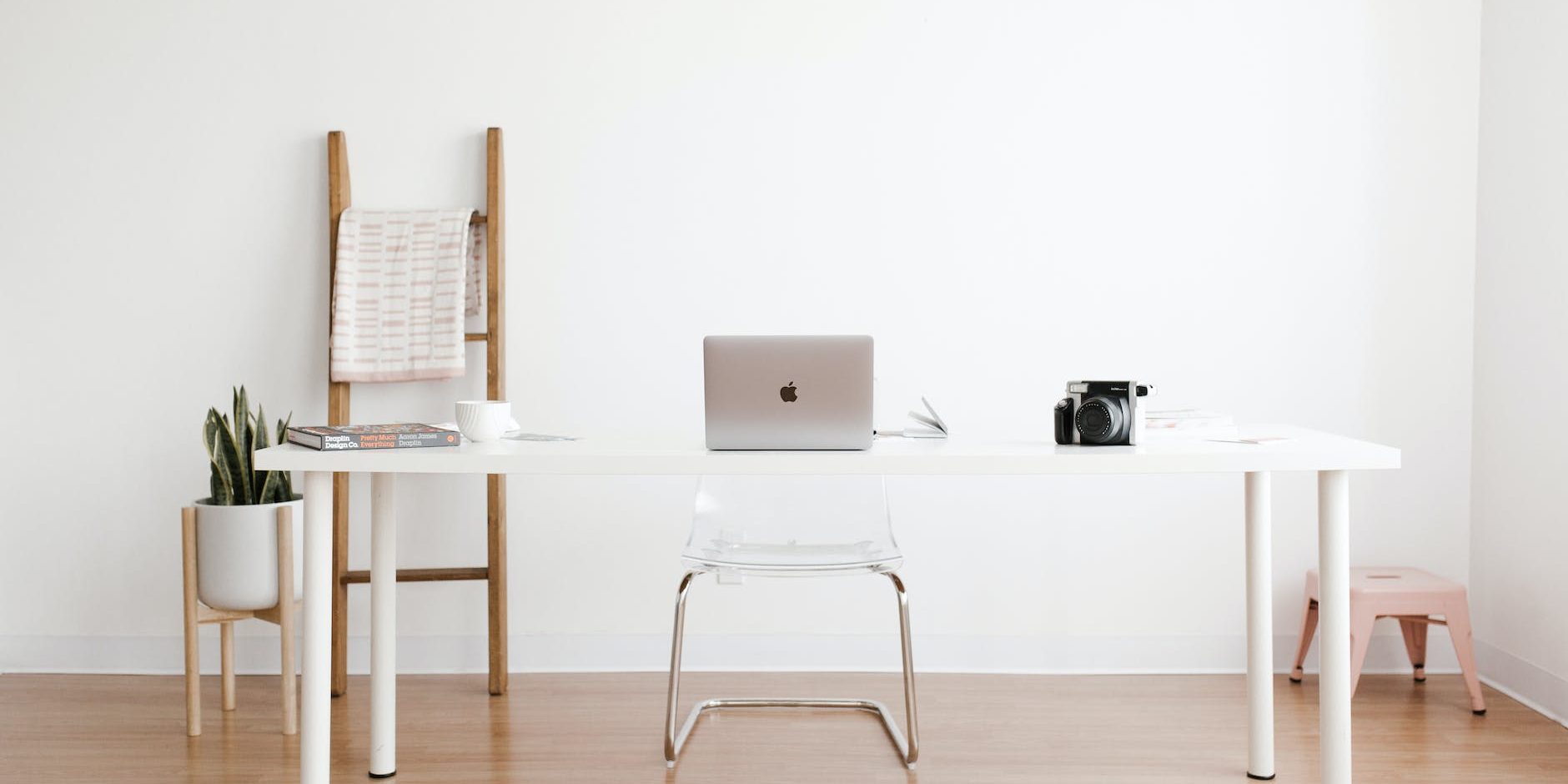 silver macbook on white table