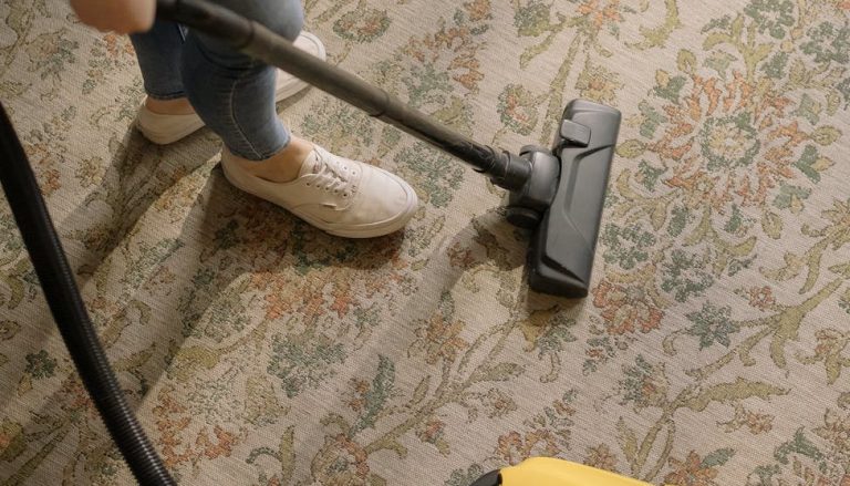 person using a yellow and black vacuum cleaner