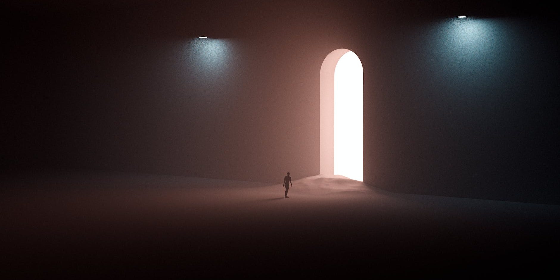 person in black shirt walking on sand