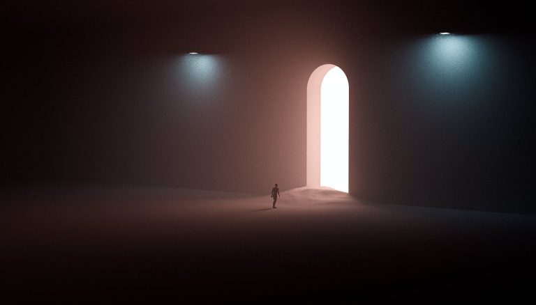 person in black shirt walking on sand