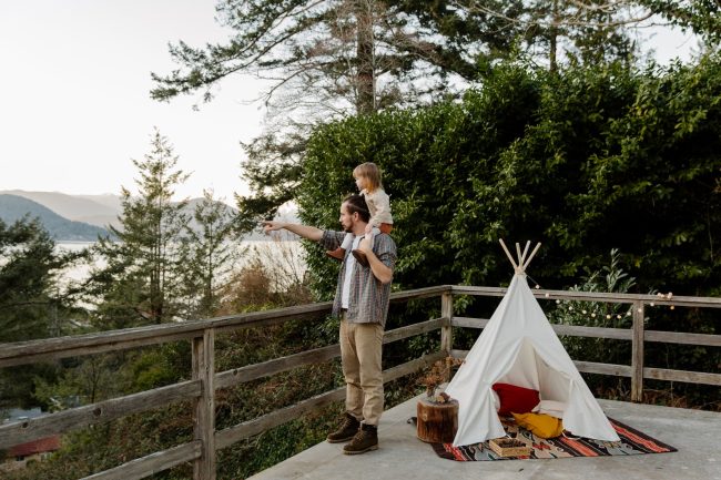 father and kid on terrace with picturesque view