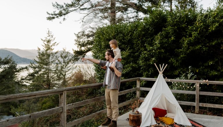 father and kid on terrace with picturesque view