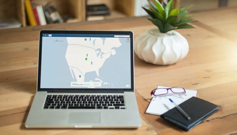 macbook pro on brown wooden table