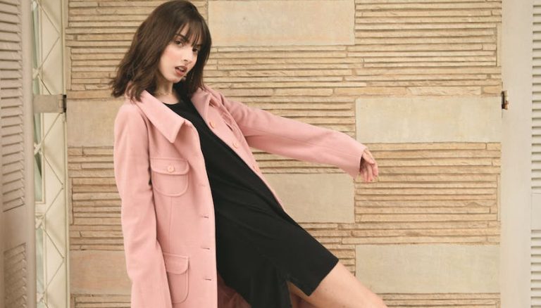 woman wearing pink overcoat and black inner top