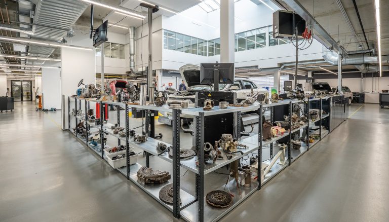 engine parts on shelves in car workshop