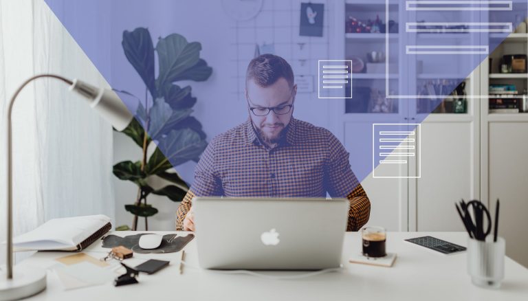 man in blue and white checkered dress shirt using silver macbook