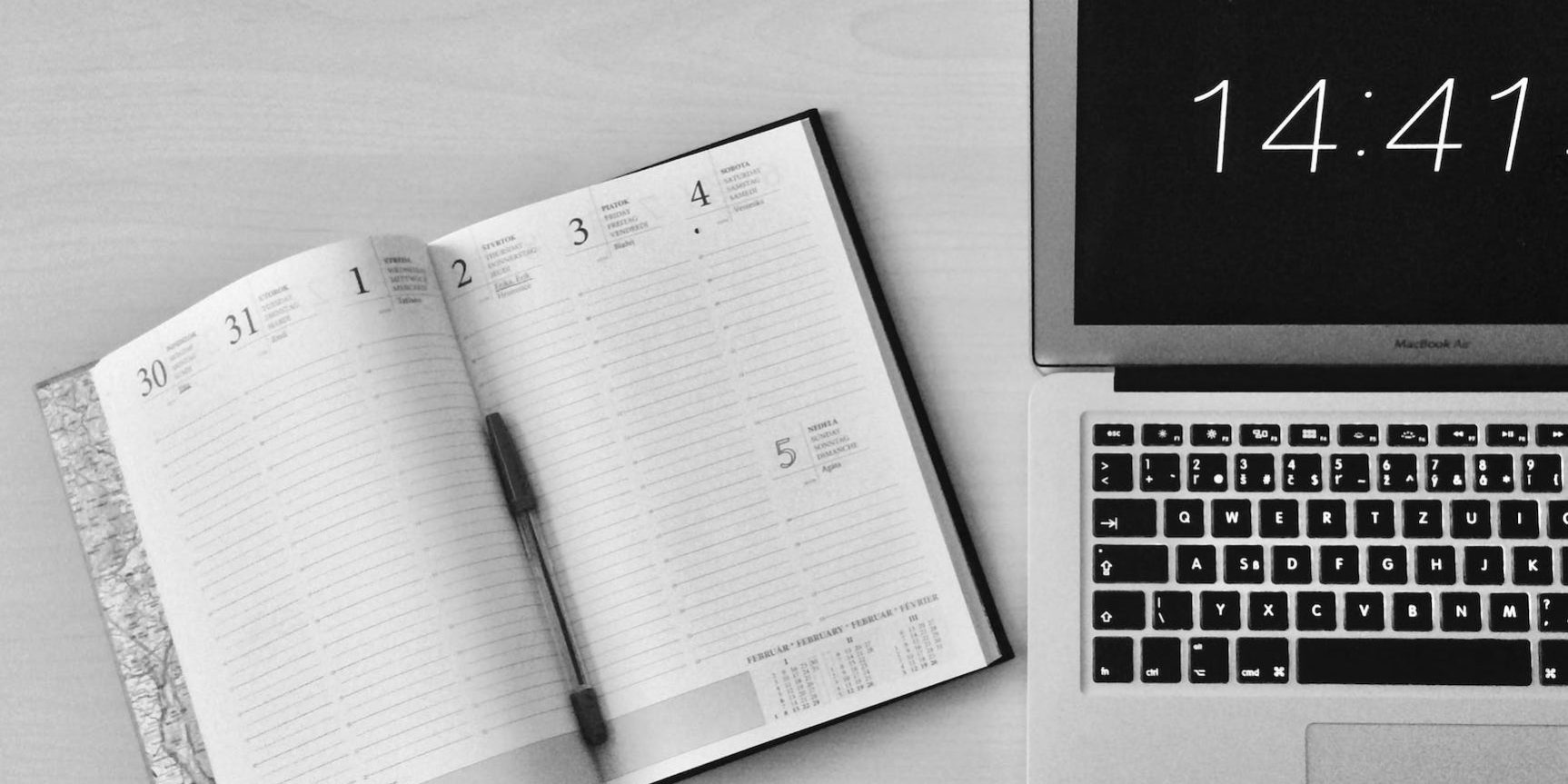 flat lay photography of unfold book beside macbook