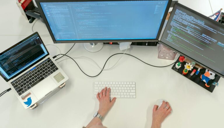 female software engineer coding on computer