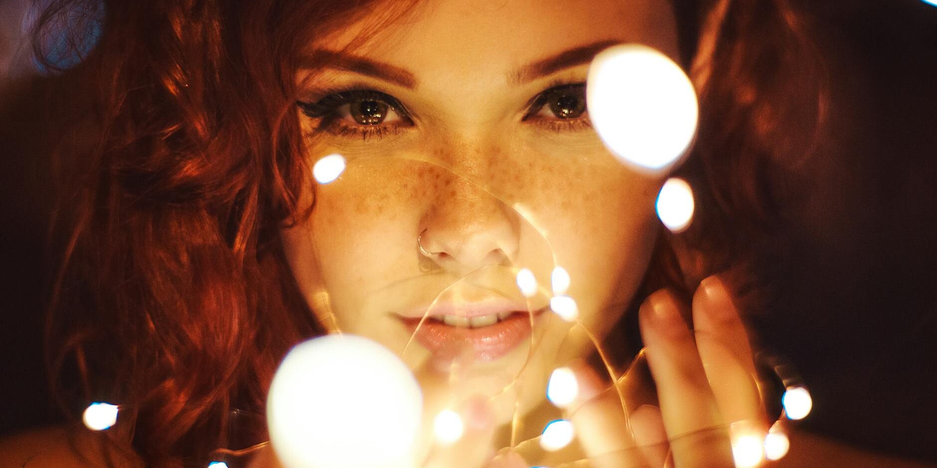 photography of a woman holding lights