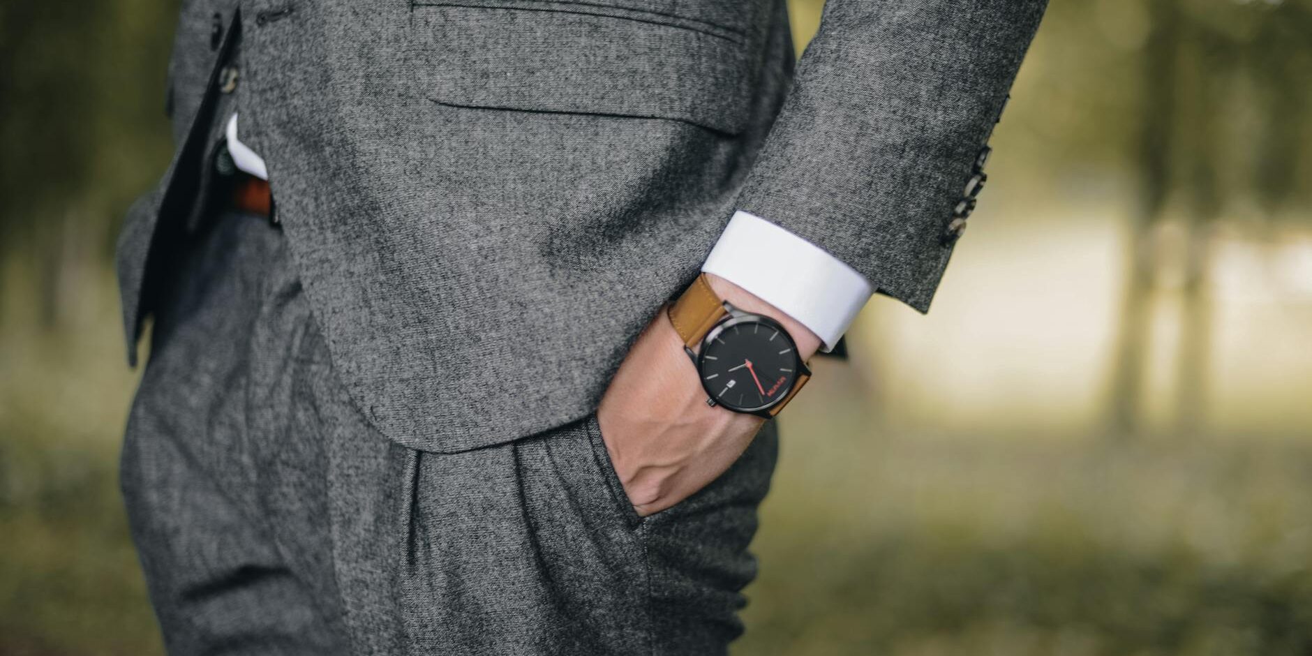 man wearing watch with hand on pocket