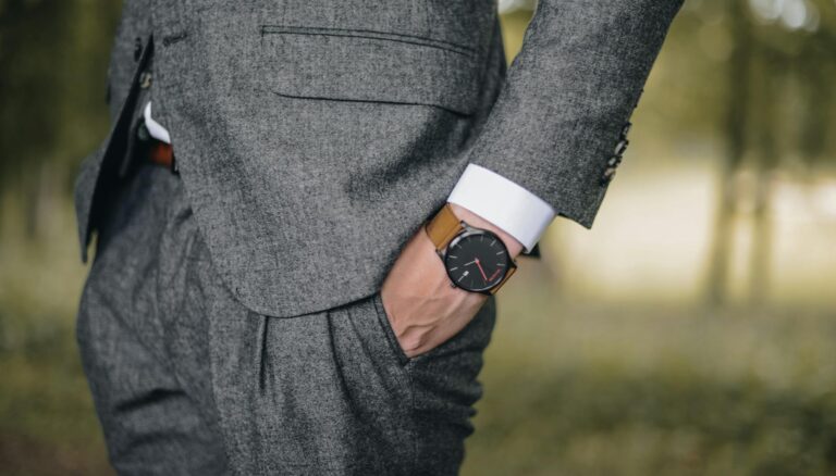 man wearing watch with hand on pocket