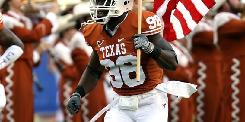 nfl player holding u s a flag on field