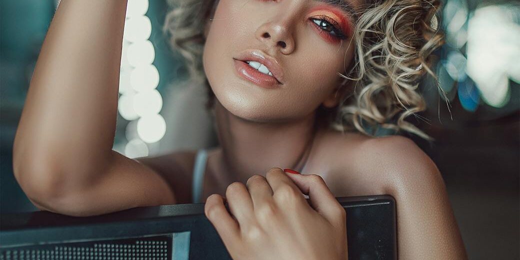 stylish young female artist with synthesizer in dressing room