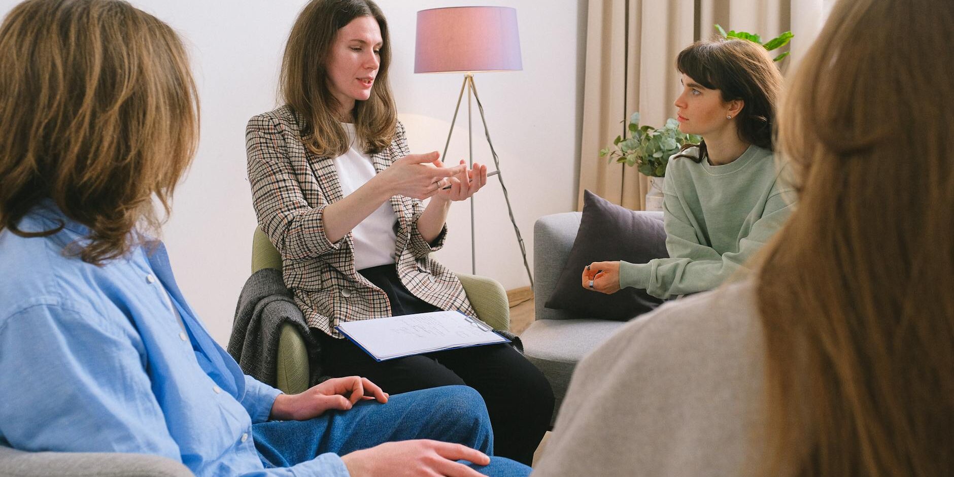 mental female specialist speaking to group of clients