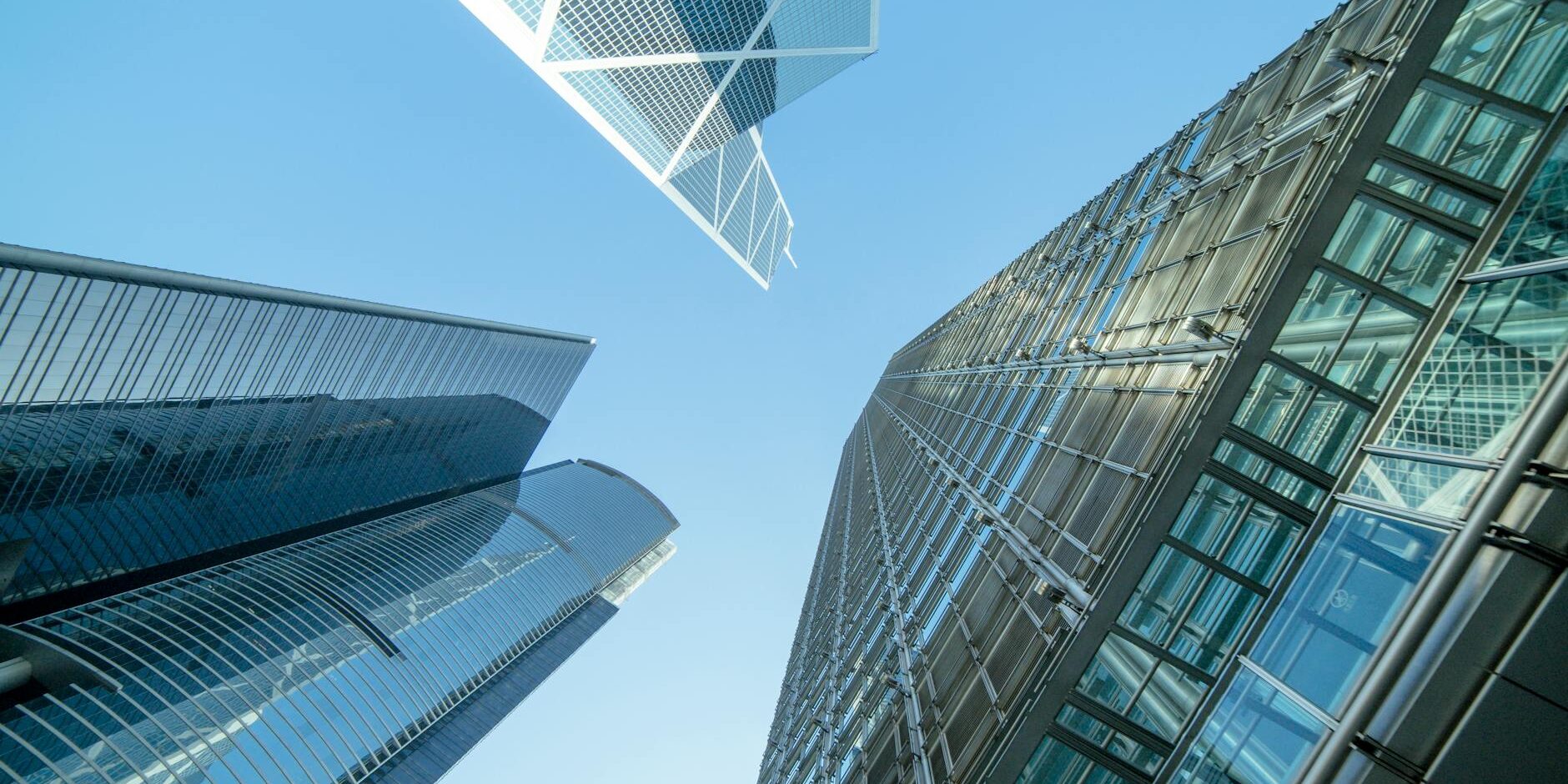 low angle photography of buildings under blue and white sky