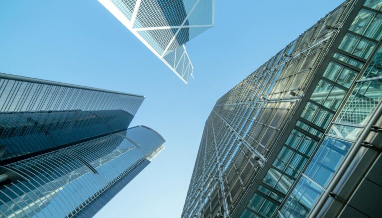 low angle photography of buildings under blue and white sky