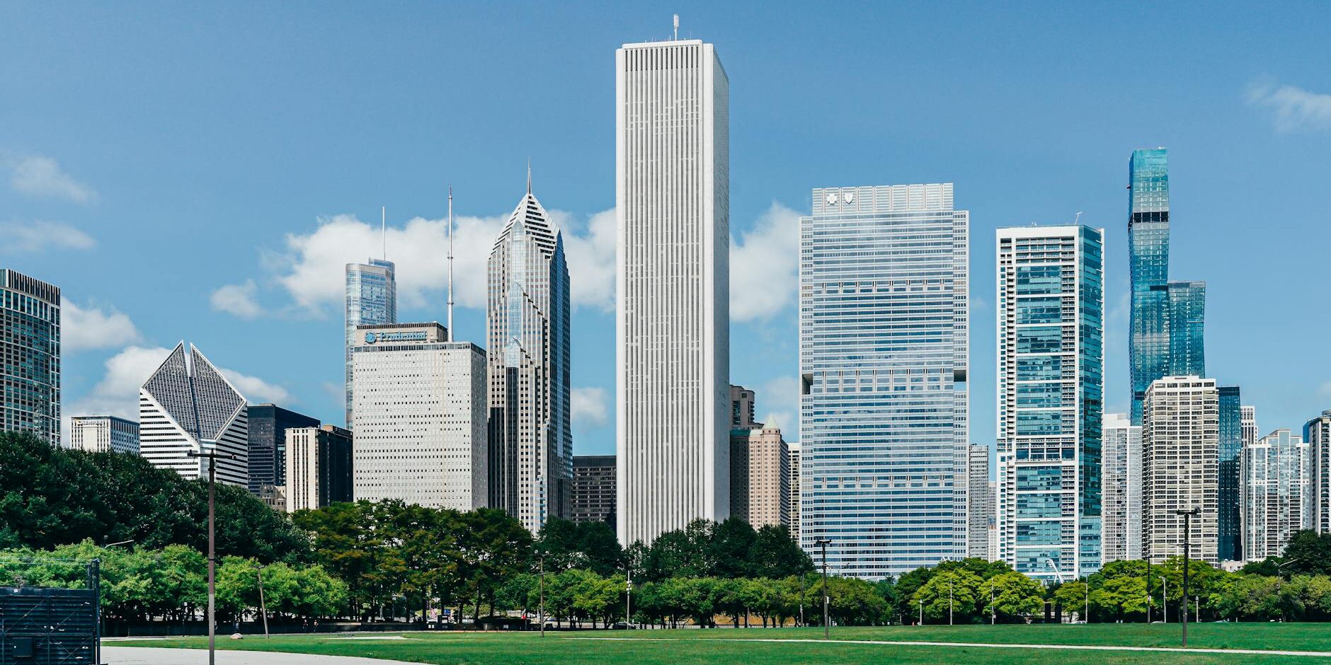 modern city district with skyscrapers near green lawn