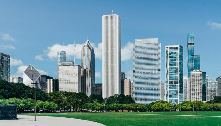 modern city district with skyscrapers near green lawn