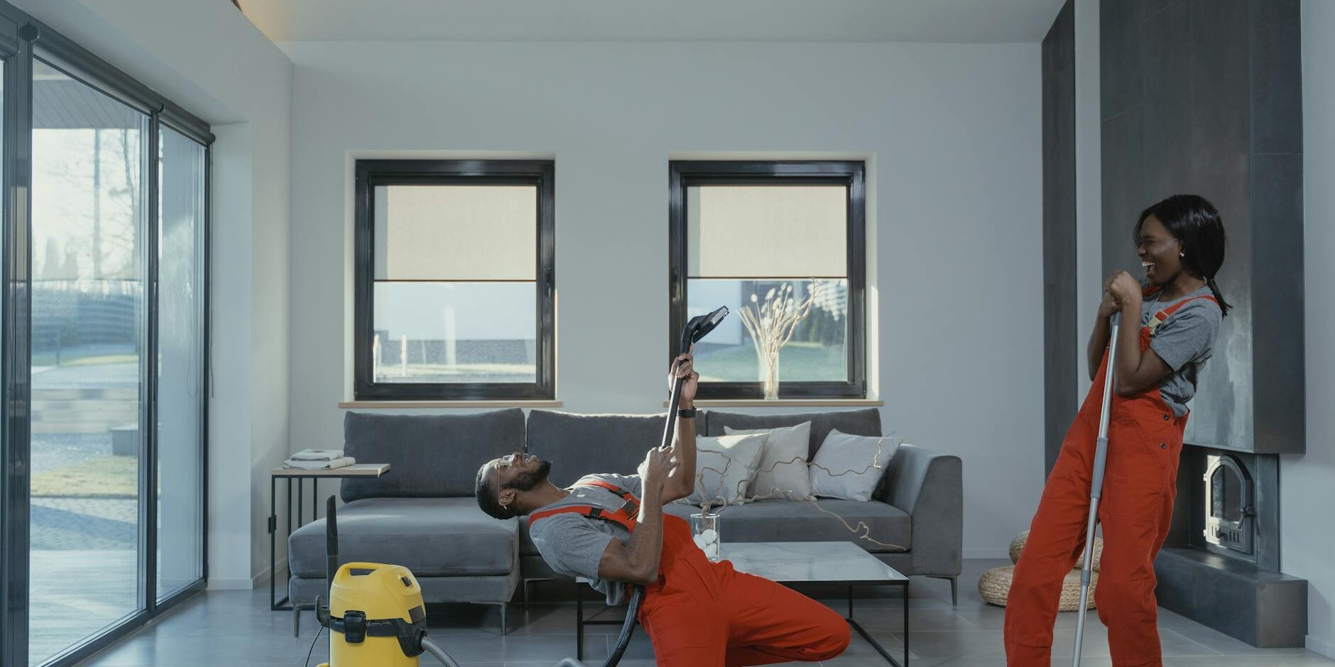 man and woman in orange overalls having fun while doing work
