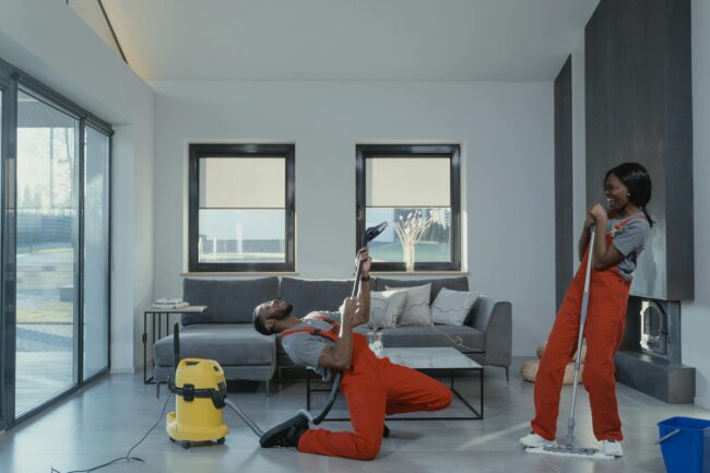 man and woman in orange overalls having fun while doing work