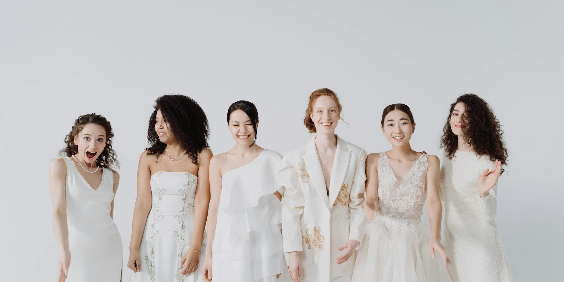a group of happy women in white dress