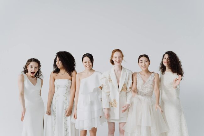 a group of happy women in white dress