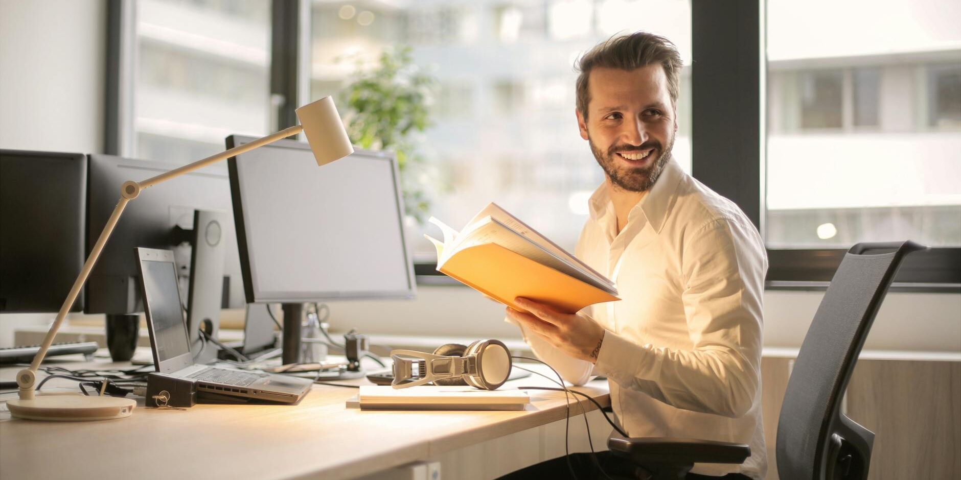 photo of man holding a book