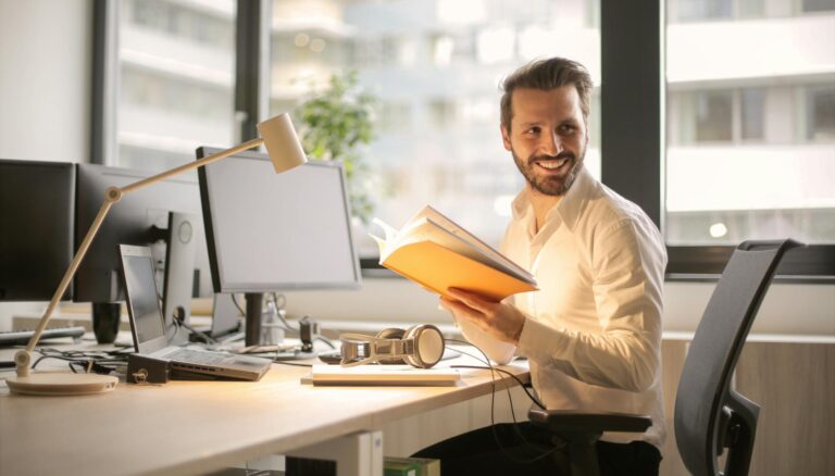 photo of man holding a book