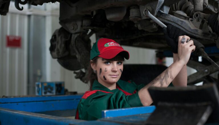woman holding gray steel wrench