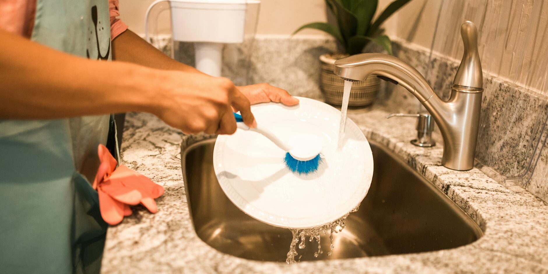 photo of a person s hands washing a white plate