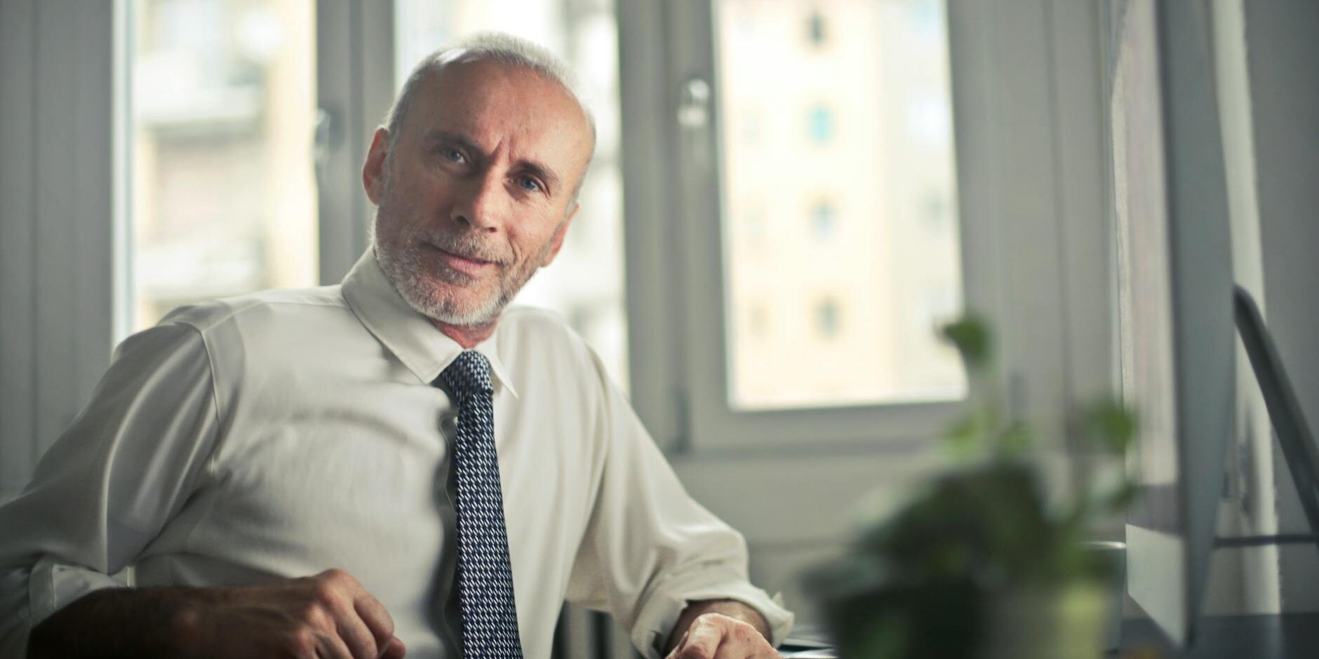 man sitting on chair beside table
