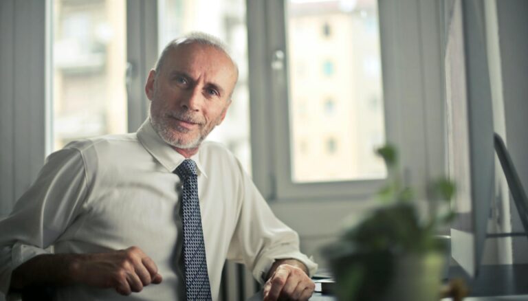 man sitting on chair beside table