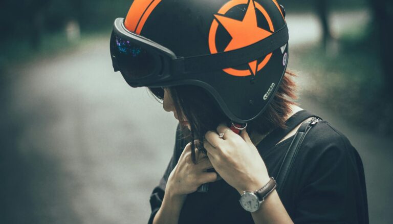 woman on black and orange half face helmet
