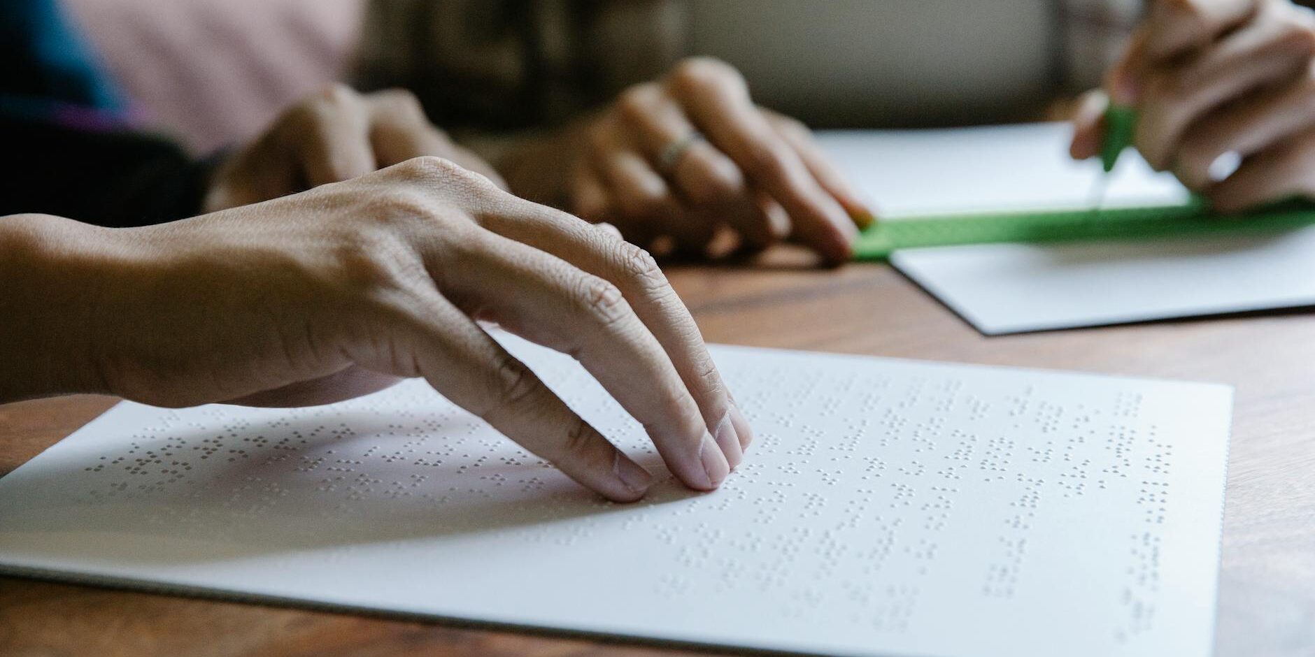 shallow focus photo of person using braille