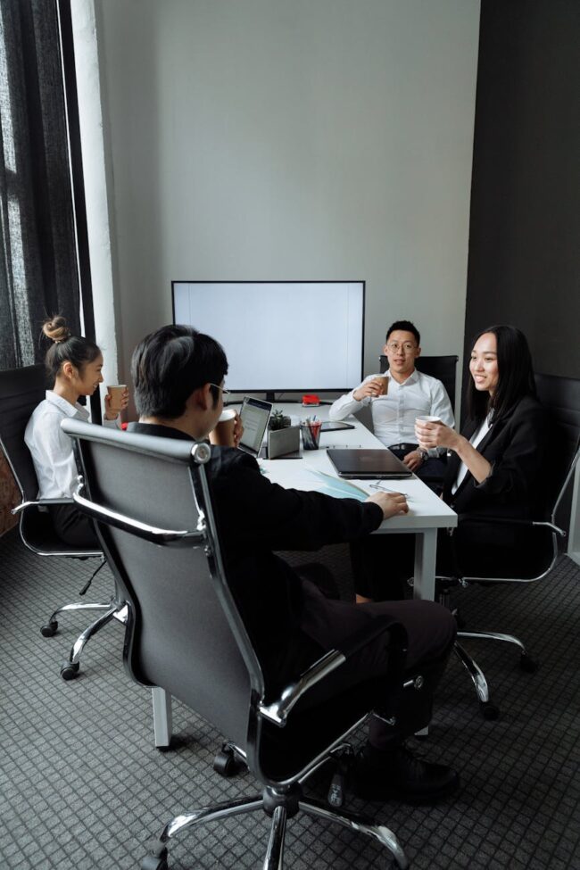 a group of people having a meeting in the office