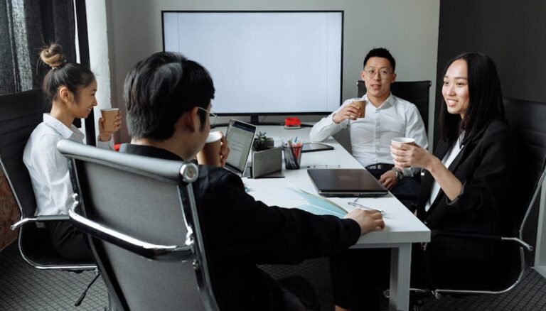 a group of people having a meeting in the office
