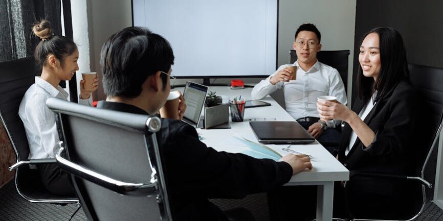 a group of people having a meeting in the office