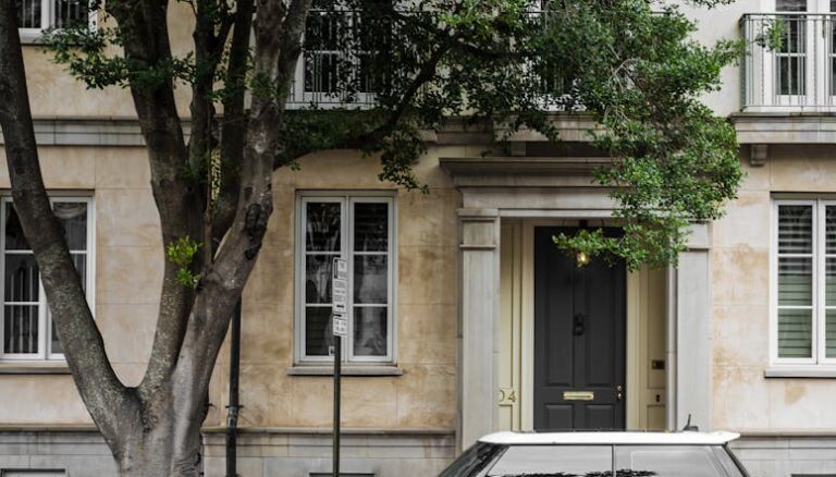 yellow mini cooper parked beside white concrete building