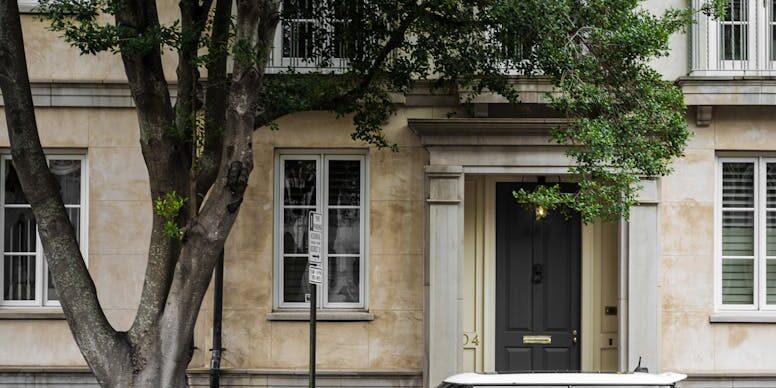 yellow mini cooper parked beside white concrete building