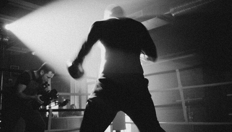 grayscale photo of man in white shirt and black pants