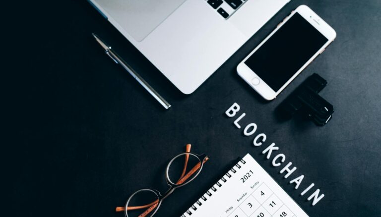 photo of eyeglasses near a silver pen