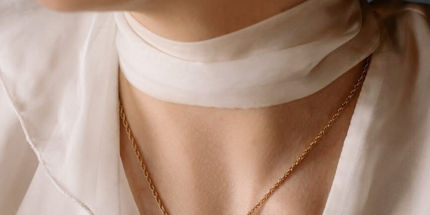 woman wearing gold necklace